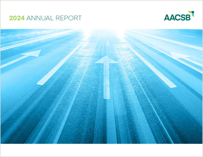 Cover of AACSB 2024 Annual Report: photo of forward-pointing arrows on a road